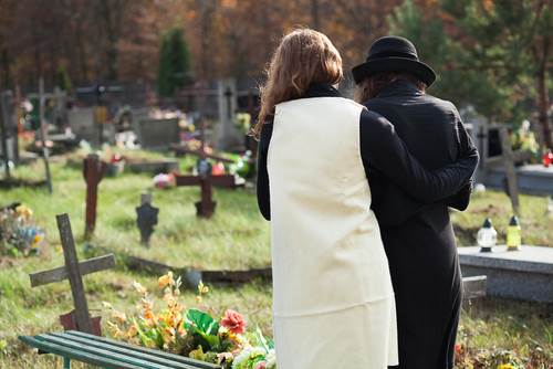 Wrongful Death Attorney - 2 women arm in arm at grave site