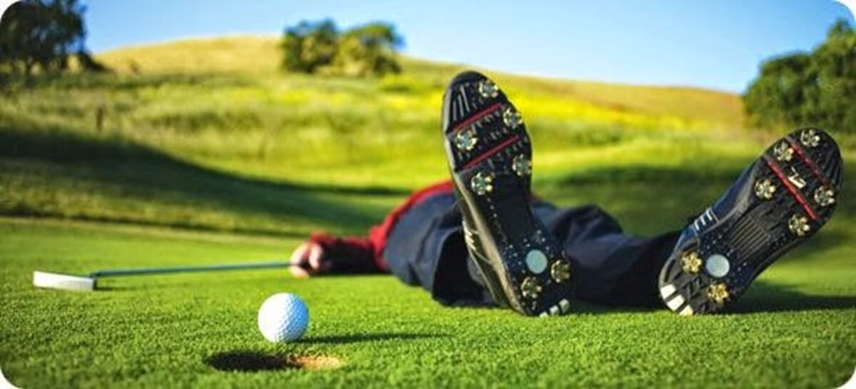 Man fallen over on green after golfball injury