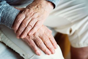 Elderly person with frail hands - hand over hand