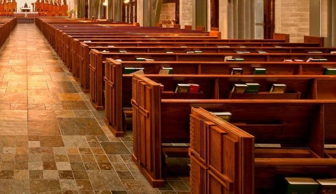 Empty rows of church pews in Catholic church