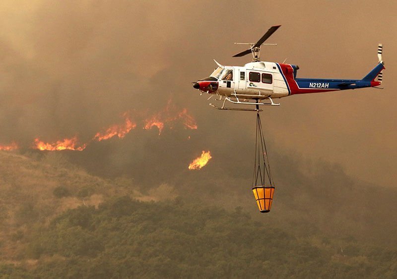 Helicopter flies over fire
