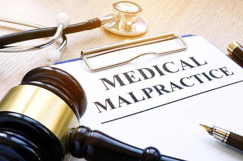 medical malpractice paperwork with gavel and stethoscope