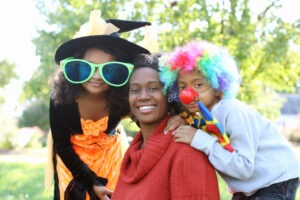 A family in halloween costumes smiling.