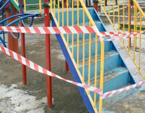 Playground with red tape around it indicating an accident occured.