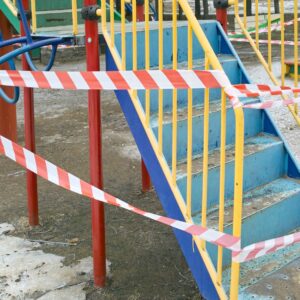 Playground with red tape around it indicating an accident occured.