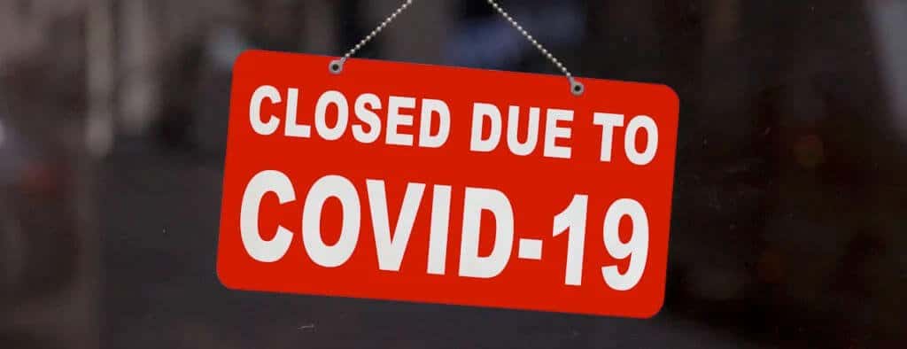 business interruption claims: sign reading "closed due to Covid-19"