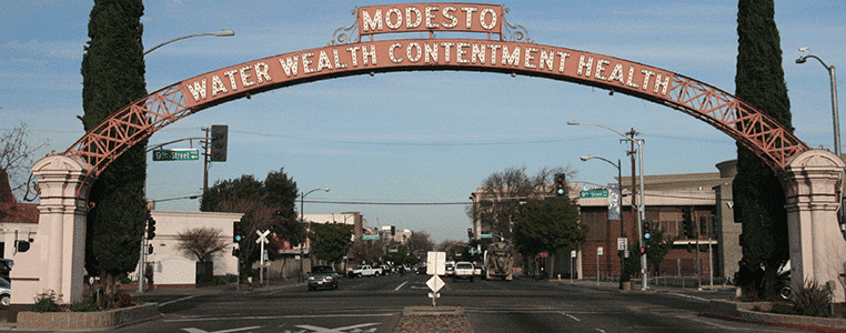 Modesto overpass sign - Water wealth contentment health