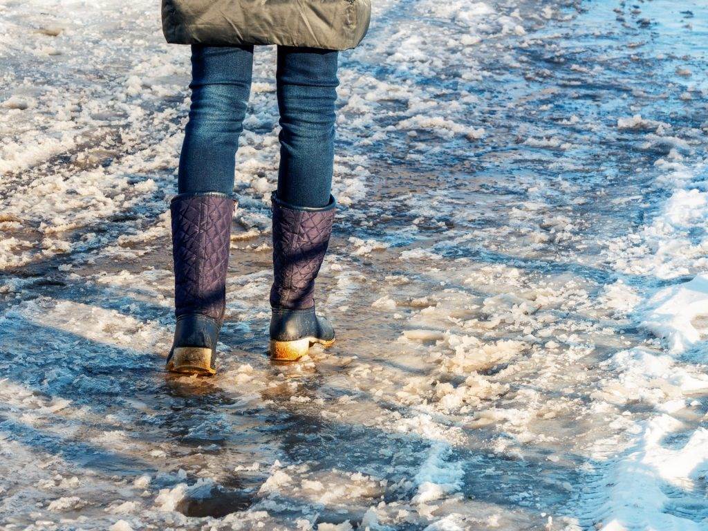 Girl walking on icy sidewalk