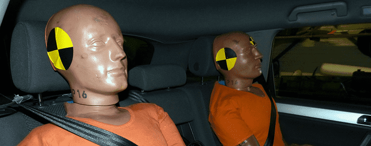 2 dummies sitting in a test driving car