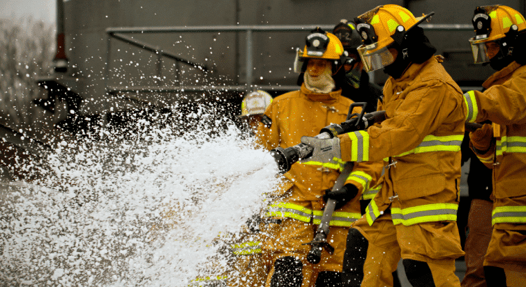 fireman spraying water from hoses