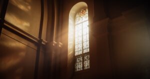 Sunlight beaming through a stained glass church window.