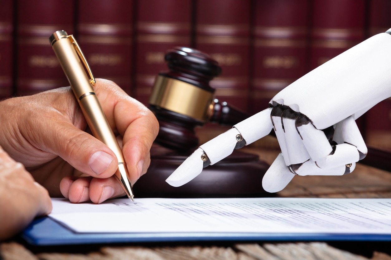 A lawyer's hands and an AI robotic hand drafting a legal document.