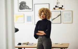 woman-with-curly-hair-standing-in-home-office