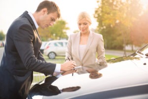 rental-car-insurance-agent-and-client-filling-up-form