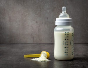 NEC Lawsuit: A bottle of baby’s milk at the gray table