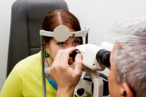 Young woman getting an eye exam for Thyroid Eye Disease