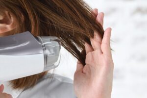 Hair being blown with a blow dryer.