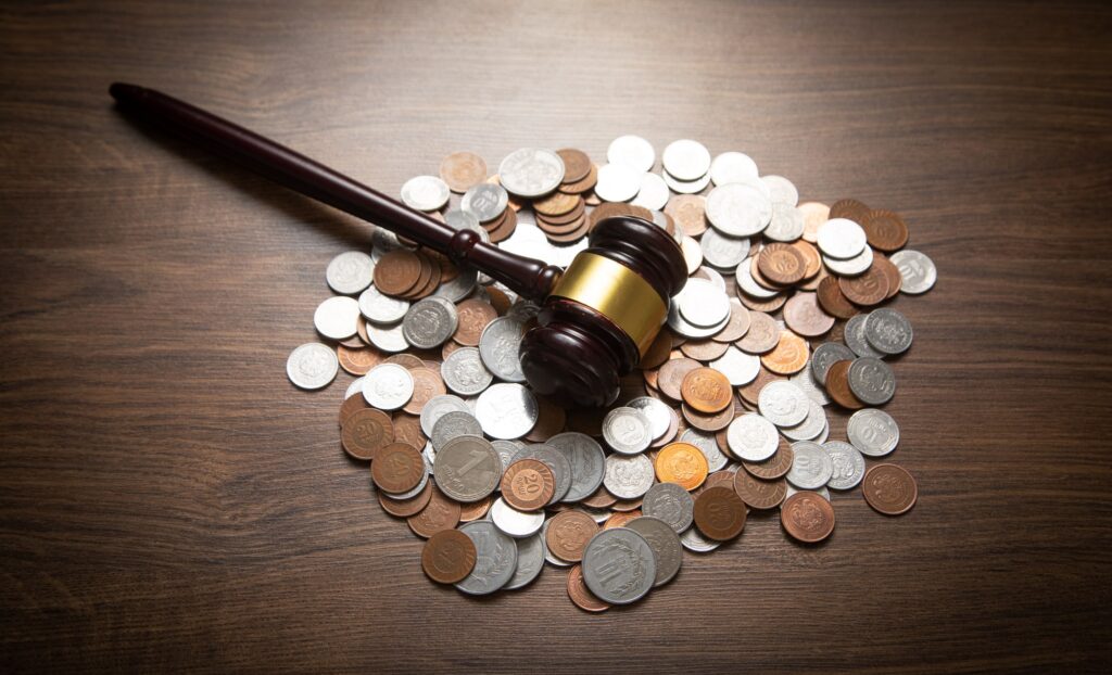 Gavel resting on a pile of coins