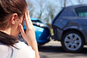 Distressed woman staring at a car accident