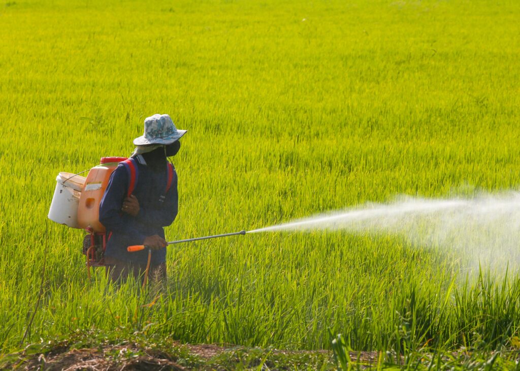 A farmer spraying pesticides on his crops.
