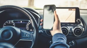 Teen looking down at phone while they drive.