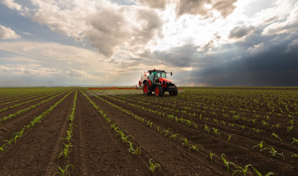 Tractor spraying paraquat in a field.