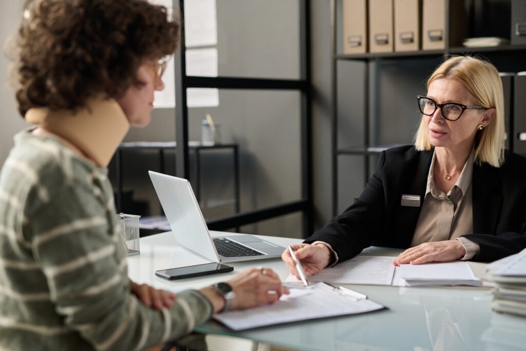 A client consulting with their lawyer about a motorcycle accident.