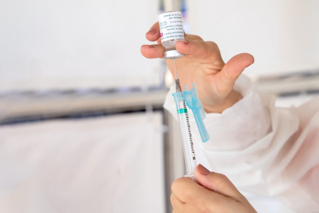 A doctor preparing a depo-provera syringe.