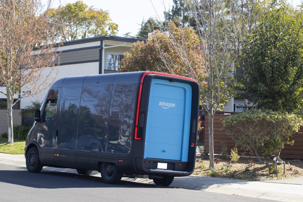 An Amazon truck parked on the curb in front of a house.