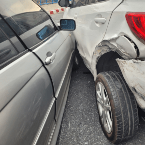 A damages white car in a brutal car accident.