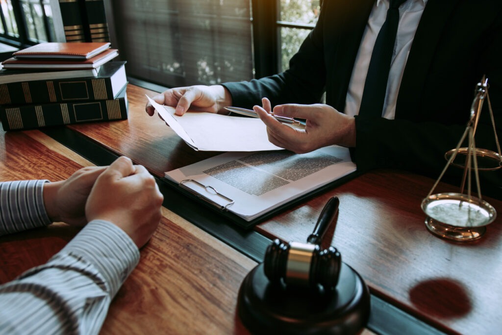 A cropped shot of a person seeking advice from a lawyer at his office