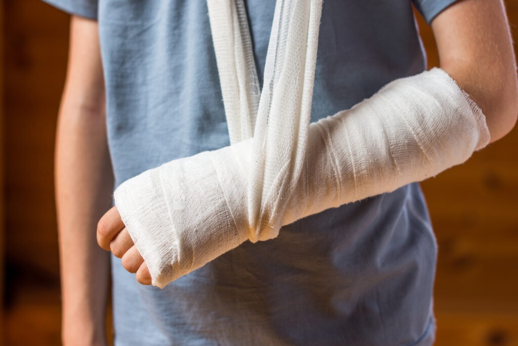 A man with his arm bandaged up in a sling.