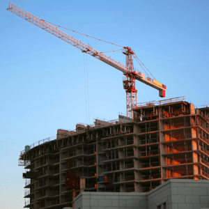 The structure of a business building being built by construction workers.