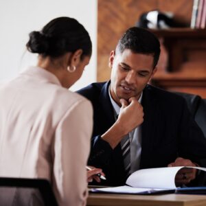 A lawyer looking over a case with their client.